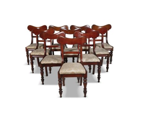 A SET OF EIGHT WILLIAM IV MAHOGANY FRAMED DINING CHAIRS, each with carved panel toprail above a conforming midrail, with upho