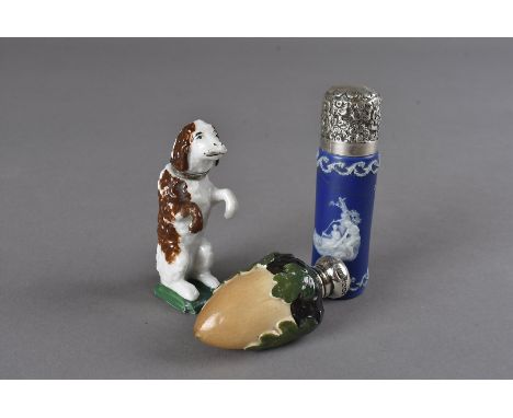 Three ceramic scent bottles, one possibly continental as a begging dog with white metal collar 7 cm H, one as an acorn and oa