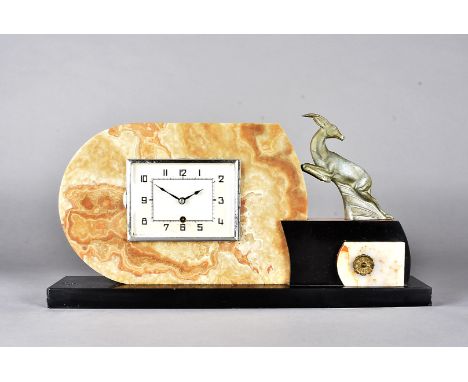 An art deco marble and slate mantel clock, the square faced dial with arabic numerals on a D shaped plinth surmounted by a le