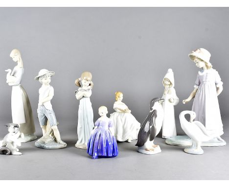 A collection of Lladro and Royal Doulton figurines, including a Lladro penguin, swan, pussy cat, girl with swan, young boy wi