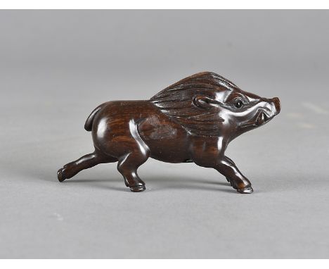 A Japanese hardwood netsuke, carved as a wild boar with black glass eyes, signed to base, 8 cm  