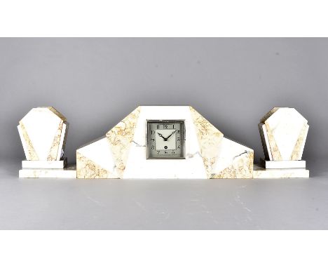 An art deco light marble clock garniture, of architectural form, supported on rectangular plinth bases with matched garniture