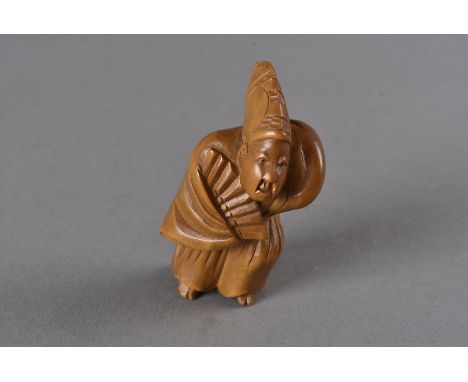 A Meiji period Japanese boxwood carved netsuke, modelled as the dancer Sambaso standing wearing an elongated hat, kimono and 