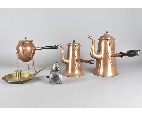 An arts and crafts copper café au lait set, matched, with coffee pot, milk and ovoid pot on tripod support, together with an 