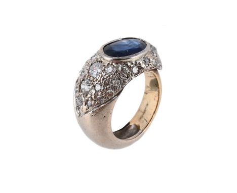 
	
		A SAPPHIRE AND DIAMOND DRESS RING 
		The oval cut sapphire within a surround of variously cut diamonds, to a tapering lo