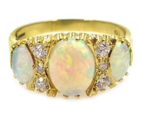 18ct gold three stone opal and six stone diamond ring, hallmarked Condition Report Approx 5gm, size P-Q, the central opal 0.9