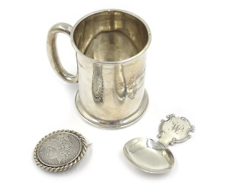 Silver mug 'George Ronald Lancelot Ingleby ...1916 Kisumu B.E.A.' , silver caddy spoon and 1880 US silver dollar brooch 4.9oz