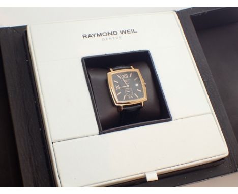 Boxed Raymond Weil gents automatic wristwatch with gold plated steel case and leather deployment strap dial displays baton ch