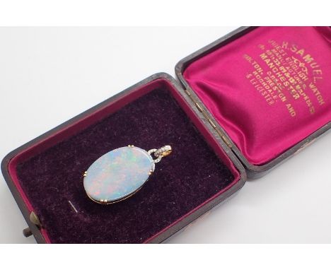 Large Australian opal set in 18ct gold with diamond surround 8.1g  L: 3 cm CONDITION REPORT: Width = 2 cm