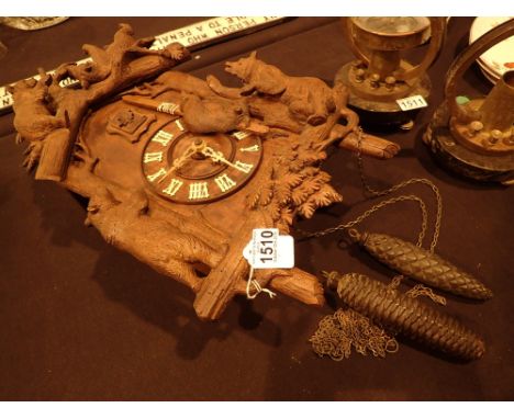 Black Forest style cuckoo clock with Roman numerals and weights decorated with brown bears CONDITION REPORT: This item is wor