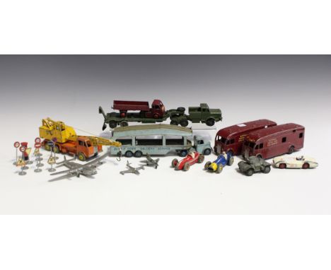 A collection of playworn Dinky Toys and Supertoys vehicles, including a No. 582 Pullmore car transporter and loading ramp, a 