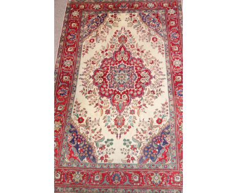 Persian Tabriz carpet, central floral medallion over cream ground spandrels red floral borders, 308cm x 203cm Condition Repor