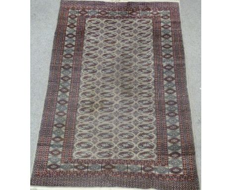 Bokhara Turkoman design carpet, with four rows of eighteen guls over grey ground, multiple boarders, 248cm x 158cm Condition 