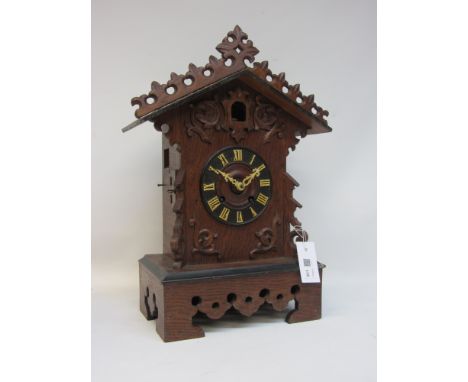 A early 20th century Coo Coo clock, signed to verso JJ Paddon with pierced pediment over carved frieze applied chapter ring, 