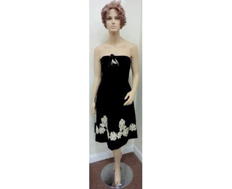 1960s black velvet cocktail dress with corsage  Condition Report No labels etc. Staining to lace along bottom of dress (front