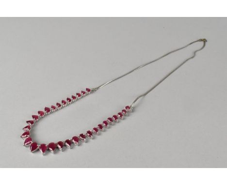 A Silver Mounted Ruby Necklace with Pear Cut Stones, Largest 7.9mm by 6mm, 52cms Long Approx