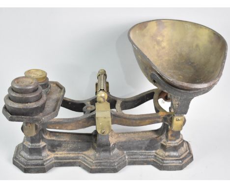 A Late Victorian/Edwardian Brass Mounted Iron Kitchen Scales with Various Weights, 41cms Wide