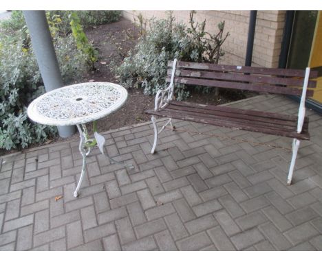 A cast iron garden table, garden bench and composite stone urn (3)  