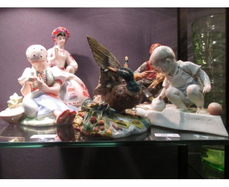 Five ceramics including a Zolnay girl with swan, Russian lady, a boy with chicken, Italian 'Making Pinochio' and a bird  bird