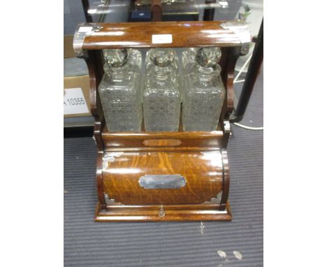 A late Victorian oak tantalus with lift up compartment, 44cm high  