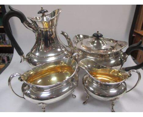 A four piece silver tea service with ebonised wooden fittings  