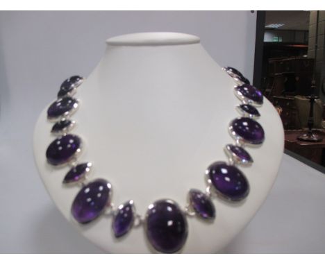 A contemporary amethyst rivière necklace, composed of graduated alternating oval and navette cabochon amethysts, collet set t