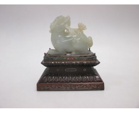 A Chinese jade Buddhist lion and cub on a wooden stand  No damage