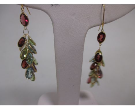 A pair of mulit gemset earrings, the small oval cut gemstones comprising garnets, peridots, citrine, amethyst and topaz all s