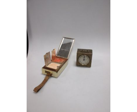 A mid 20th century lady's evening minaudiere in cream enamel and gilt metal together with a small brass desk clock (2)  