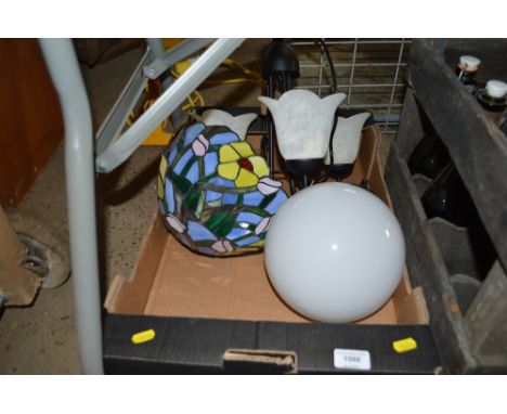A box containing various light fittings to include a Tiffany style lamp shade 