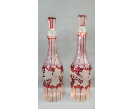 Pair of ruby flashed glass fruit and vine patterned decanters with stoppers, 33 cm high, (2) 