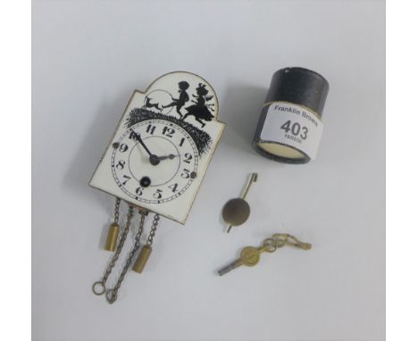 Miniature white enamelled clock face, complete with pendulum and key, 8cm 