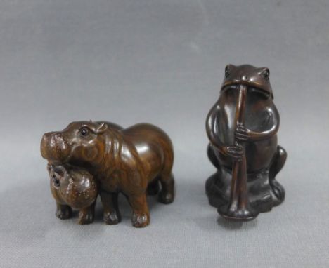 Two Japanese Netsuke's to include a Frog playing a musical instrument, together with a Netsuke of two Hippos, signed (2)