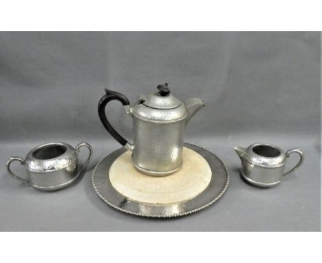 Hammered pewter three piece tea set, comprising teapot, milk jug, sugar bowl and an Epns bread board (4) 