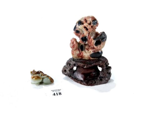 A CHINESE MOTTLED BROWN/GREEN JADE OF AN ANIMAL AND HER YOUNG (losses to front feet), 2" long and a carved SOAPSTONE FIGURE o