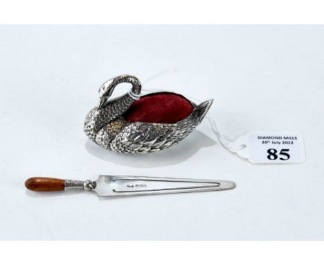 AN EDWARDIAN SILVER SWAN-FORM PIN CUSHION, maker: Adie &amp; Lovekin Ltd, Birmingham 1906, 2 1/2" long, and a George V silver