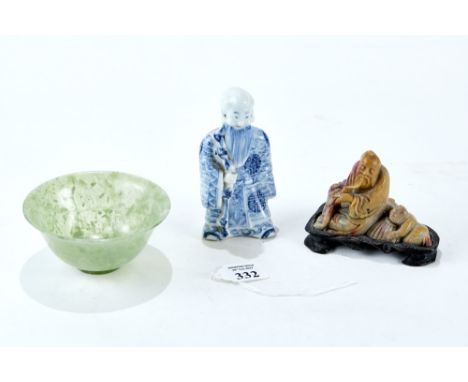 A CHINESE BLUE AND WHITE PORCELAIN FIGURE OF AN IMMORTAL standing holding a staff, 4 1/2" high, a small transluscent green JA