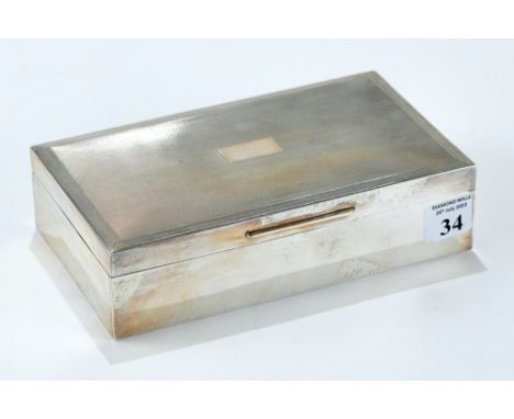 AN ELIZABETH II RECTANGULAR SILVER CIGARETTE BOX with engine turned lid, maker: S. J. R., London 1971. £40-£60