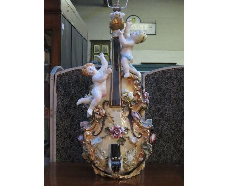 CONTINENTAL STYLE RELIEF DECORATED CERAMIC VIOLIN FORM TABLE, APPROXIMATELY 65cm HIGH 