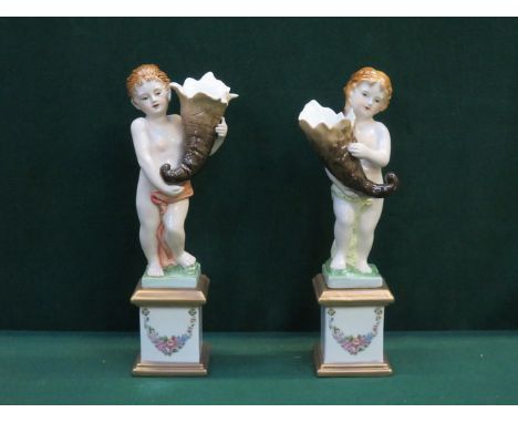 PAIR OF DRESDEN HANDPAINTED AND GILDED FIGURE FORM VASE ON PEDESTAL STYLE SUPPORTS, APPROXIMATELY 32cm HIGH 