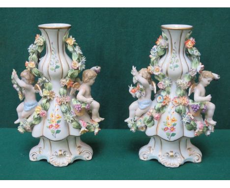 PAIR OF MEISSEN STYLE HANDPAINTED AND GILDED CERAMIC VASE, RELIEF DECORATED WITH CHERUBS AND FLORAL SWAGS, APPROXIMATELY 24cm