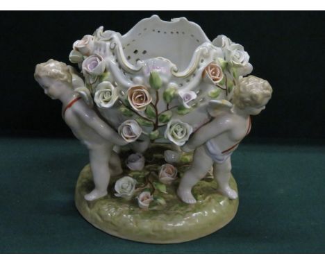 MEISSEN STYLE HANDPAINTED AND GILDED RELIEF DECORATED CERAMIC CENTRE PIECE FEATURING THREE CHERUBS, APPROXIMATELY 19cm HIGH 