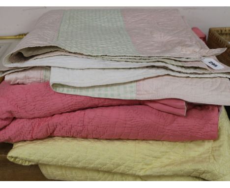 A rose pink and light pink reversible quilt, another reversible with yellow, the other mint green gingham and pink (3)