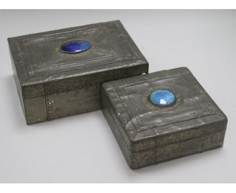 Two Arts & Crafts style pewter-covered wooden boxes, each with blue enamel oval cabochon to cover, punched 'strapwork' decora