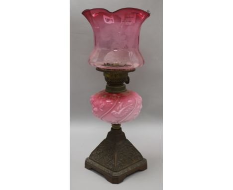A cranberry shaded oil lamp