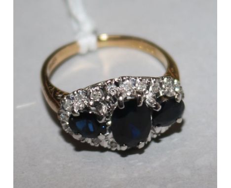 An 18ct gold, sapphire and diamond cluster ring, size M.