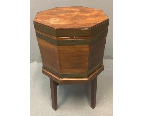 Georgian mahogany octagonal cellarette/wine cooler, the shaped top with ebonised inlay with brass banding and mask lion mount
