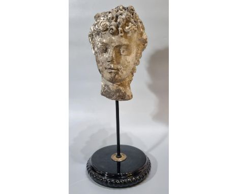 After the Antiquity, Marble head of a Greek woman with a band on her head, on circular black enamel pedestel base. 42cm high 
