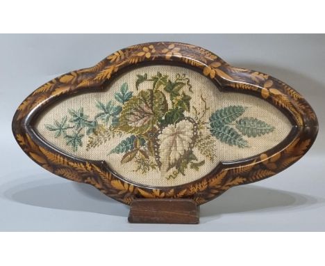 Victorian ebonised moulded stand with indented frame decorated with leaves and foliage, the centre under clear glass with a s
