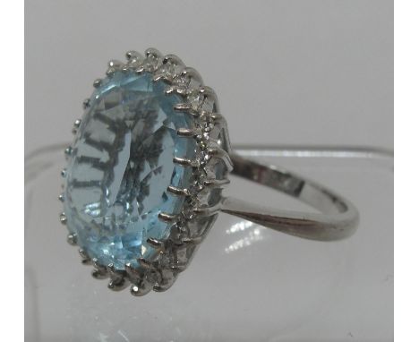 Aquamarine and diamond ring set in 18ct white gold.  Aquamarine approx 16 x 14mm surrounded by twenty four small diamonds.  R